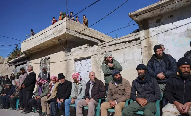 Local residents gather to welcome a delegation showing support after Israeli troops raided the village on Nov. 28, in Beit Jin, southwestern Syria, Monday, Dec. 1, 2025. (AP Photo/Omar Albam)