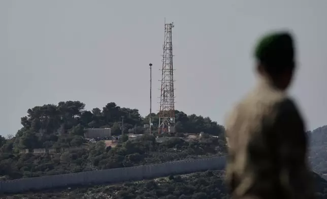 FILE - A Lebanese army soldier looks at the Israeli military post of Hanita from the Alma al-Shaab border village with Israel, south Lebanon, southern Lebanon, Nov. 28, 2025. (AP Photo/Bilal Hussein, File)