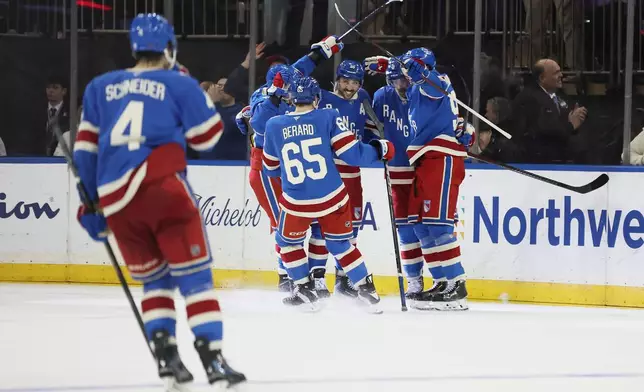 The New York Rangers celebrate their win in overtime during an NHL hockey game against the Montréal Canadiens, Saturday, Dec. 13, 2025, in New York. (AP Photo/Heather Khalifa)