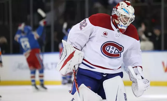 Montréal Canadiens goaltender Jacob Fowler (32) skates off the ice while the New York Rangers celebrate an overtime goal by J.T. Miller during an NHL hockey game, Saturday, Dec. 13, 2025, in New York. (AP Photo/Heather Khalifa)