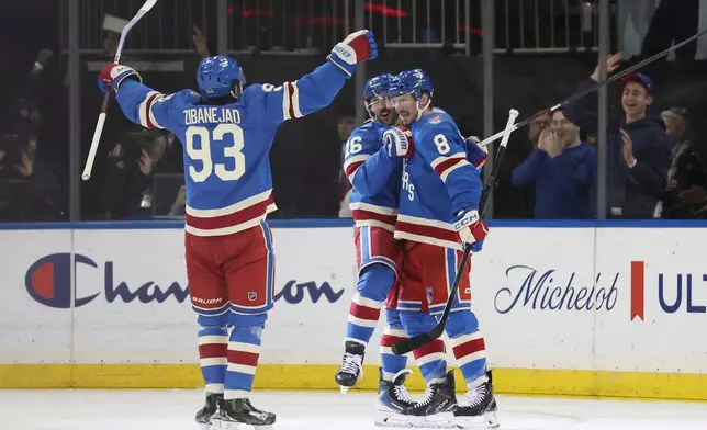 The New York Rangers celebrate an overtime goal by J.T. Miller (8) during an NHL hockey game against the Montréal Canadiens, Saturday, Dec. 13, 2025, in New York. (AP Photo/Heather Khalifa)