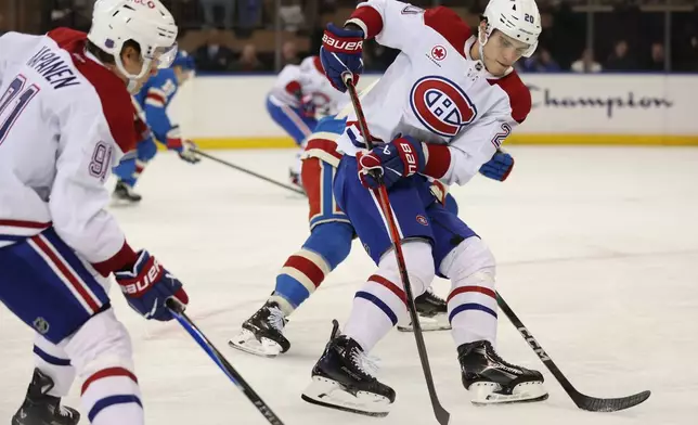 Montréal Canadiens' Juraj Slafkovský (20) looks to pass the puck during the second period of an NHL hockey game against the New York Rangers, Saturday, Dec. 13, 2025, in New York. (AP Photo/Heather Khalifa)