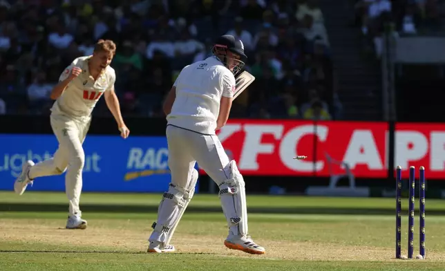 Australia's Cameron Green, left, celebrates after bowling England's Gus Atkinson, right, during their Ashes cricket test match in Melbourne, Friday, Dec. 26, 2025. (AP Photo/Hamish Blair)