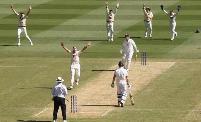 Australia's Scott Boland, second left, along with teammates, successfully appeal for a LBW decision on England's Harry Brook, third right, during their Ashes cricket test match in Melbourne, Friday, Dec. 26, 2025. (AP Photo/Hamish Blair)