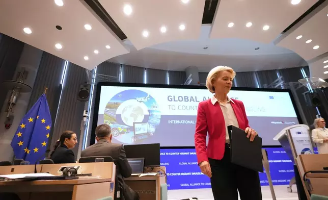 European Commission President Ursula von der Leyen steps off the podium after addressing a Conference of the Global Alliance to Counter Migrant Smuggling at the EU Charlemagne building in Brussels, Wednesday, Dec. 10, 2025. (AP Photo/Virginia Mayo)