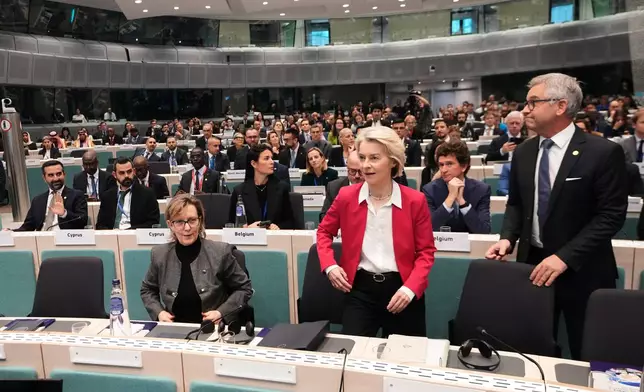 From left, European Commissioner for Financial Services Maria Luis De Albuquerque, European Commission President Ursula von der Leyen and European Commissioner for Internal Affairs and Migration Magnus Brunner arrive for a Conference of the Global Alliance to Counter Migrant Smuggling at the EU Charlemagne building in Brussels, Wednesday, Dec. 10, 2025. (AP Photo/Virginia Mayo)