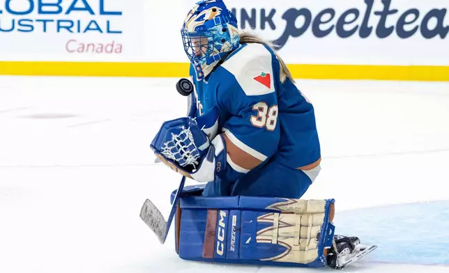 Vancouver Goldeneyess goaltender Emerance Maschmeyer stops the puck against the New York Sirens during the second period of a PWHL hockey game in Vancouver, British Columbia, Saturday, Dec. 6, 2025. (Ethan Cairns/The Canadian Press via AP)