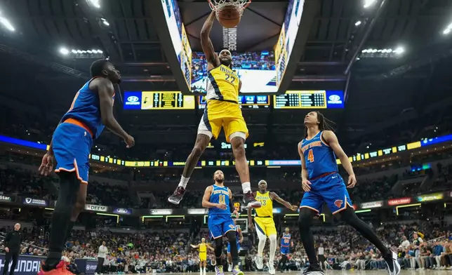 Indiana Pacers forward Isaiah Jackson (22) dunks in front of New York Knicks forward Pacome Dadiet (4) during the first half of an NBA basketball game in Indianapolis, Thursday, Dec. 18, 2025. (AP Photo/AJ Mast)