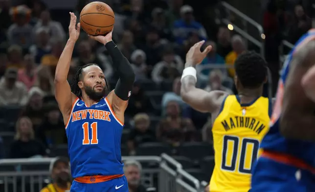 New York Knicks guard Jalen Brunson (11) shoots in front of Indiana Pacers guard Bennedict Mathurin (00) during the first half of an NBA basketball game in Indianapolis, Thursday, Dec. 18, 2025. (AP Photo/AJ Mast)