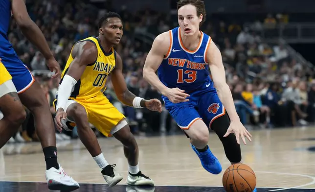 New York Knicks guard Tyler Kolek (13) goes around Indiana Pacers guard Bennedict Mathurin (00) during the first half of an NBA basketball game in Indianapolis, Thursday, Dec. 18, 2025. (AP Photo/AJ Mast)