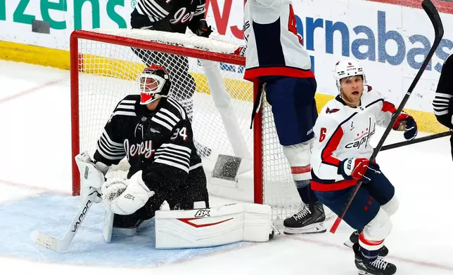 Washington Capitals defenseman Jakob Chychrun (6) reacts after scoring the game winning goal against New Jersey Devils goaltender Jake Allen (34) during overtime of an NHL hockey game, Saturday, Dec. 27, 2025, in Newark, N.J. (AP Photo/Noah K. Murray)
