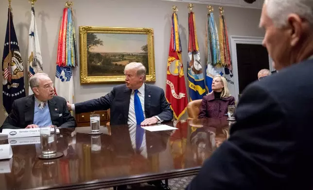 FILE - President Donald Trump, accompanied by Sen. Chuck Grassley, R-Iowa, left, and Secretary of Homeland Security Kirstjen Nielsen, right, speaks at a meeting on immigration with Republican Senators in the Roosevelt Room at the White House, Thursday, Jan. 4, 2018, in Washington. (AP Photo/Andrew Harnik, File)