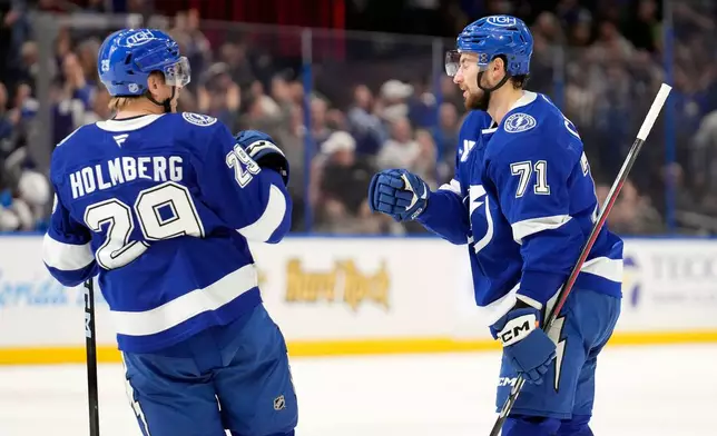 Tampa Bay Lightning center Anthony Cirelli (71) celebrates his goal against the St. Louis Blues with right wing Pontus Holmberg (29) during the second period of an NHL hockey game Monday, Dec. 22, 2025, in Tampa, Fla. (AP Photo/Chris O'Meara)