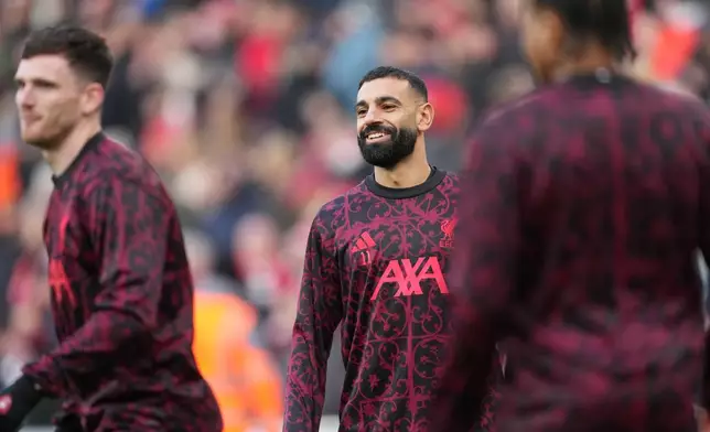 Liverpool's Mohamed Salah, centre, warms up prior to the English Premier League soccer match between Liverpool and Brighton and Hove Albion in Liverpool, England, Saturday, Dec. 13, 2025. (AP Photo/Jon Super)