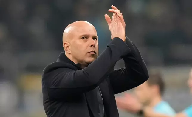 Liverpool's manager Arne Slot applauds at the end of a Champions League, league phase, soccer match between Inter Milan and Liverpool in Milan, Italy, Tuesday, Dec.9, 2025. (AP Photo/Luca Bruno)