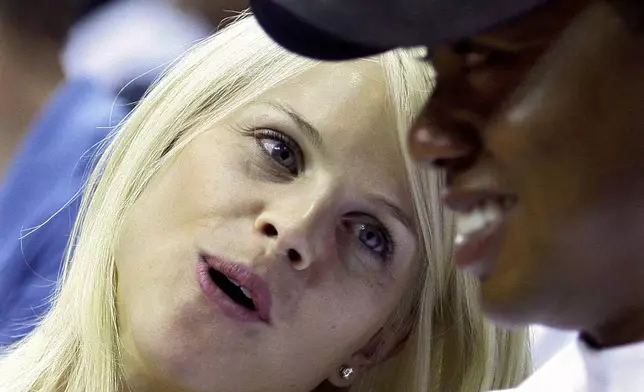 FILE - Elin Nordegren talks to her husband, golfer Tiger Woods, during the first quarter of Game 4 of the NBA basketball finals in Orlando, Fla., June 11, 2009. (AP Photo/David J. Phillip, File)