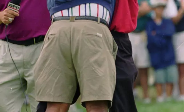 FILE - Tiger Woods embraces his father, Earl, after Tiger defeated George Marucci for in the final round of the 1995 Centennial U.S. Amateur Golf Championship, Sunday, Aug. 27, 1995, at the Newport Country Club in Newport, R.I. (AP Photo/Matt York, File)