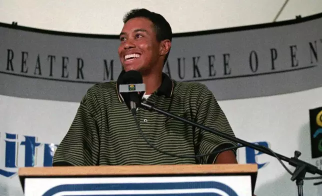 FILE - Tiger Woods answers questions at a news conference following play in the pro-am at the Greater Milwaukee Open Wednesday, Aug. 28, 1996, at the Brown Deer Golf Course, in Milwaukee. (AP Photo/Peter Zuzga, File)