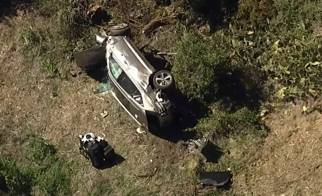 FILE - In this aerial image take from video provided by KABC-TV, a vehicle rest on its side after a rollover accident involving golfer Tiger Woods along a road in the Rancho Palos Verdes suburb of Los Angeles, Tuesday, Feb. 23, 2021. (KABC-TV via AP, File)