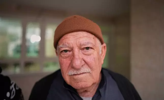 Syrian refugee Abdulilah Amin Dawoud, 73, poses for a picture at his home in Irbil, Iraq, Nov. 16, 2025. (AP Photo/Farid Abdulwahed)