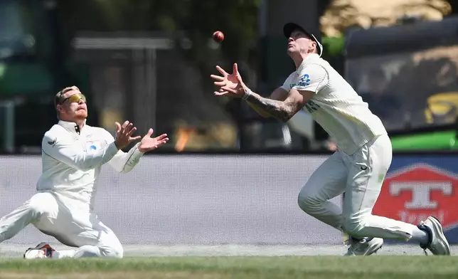 New Zealand fielders Blair Tickner, right, and Glenn Phillips are unable to field a ball while playing the West Indies on Day 5 of their cricket test match in Christchurch, New Zealand, Saturday, Dec. 6, 2025. (Chris Symes/Photosport via AP)