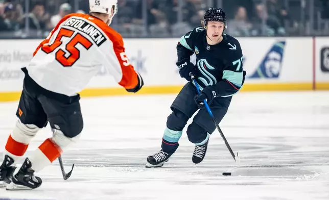 Seattle Kraken forward Berkly Catton skates against Philadelphia Flyers defenseman Rasmus Ristolainen (55) during the first period of an NHL hockey game, Sunday, Dec. 28, 2025, in Seattle. (AP Photo/Stephen Brashear)