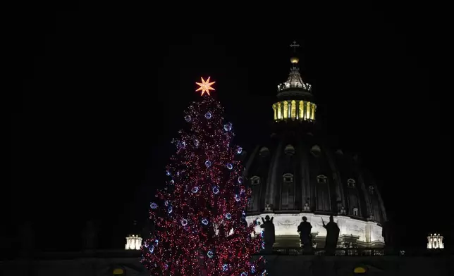 A 27-meter fir tree from the Ultimo valley in South Tyrol, Italy, is lit up as Christmas tree in St. Peter's Square at the Vatican, Monday, Dec. 15, 2025. (AP Photo/Alessandra Tarantino)