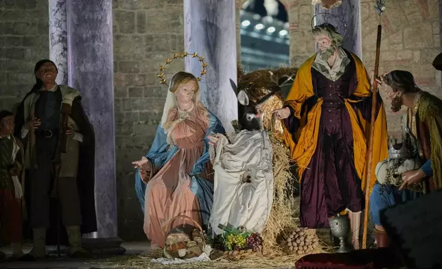 A nativity scene designed and crafted in Nocera Inferiore and Sarno in southern Italy, is lit up in St. Peter's Square at the Vatican, Monday, Dec.15, 2025. (AP Photo/Alessandra Tarantino)
