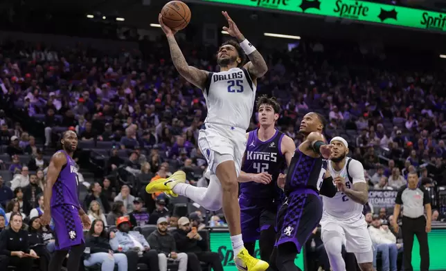 Dallas Mavericks forward P.J. Washington Jr. (25) attempts a layup as he's fouled during the first half of an NBA basketball game against the Sacramento Kings, Saturday, Dec. 27, 2025, in Sacramento, Calif. (AP Photo/Scott Marshall)