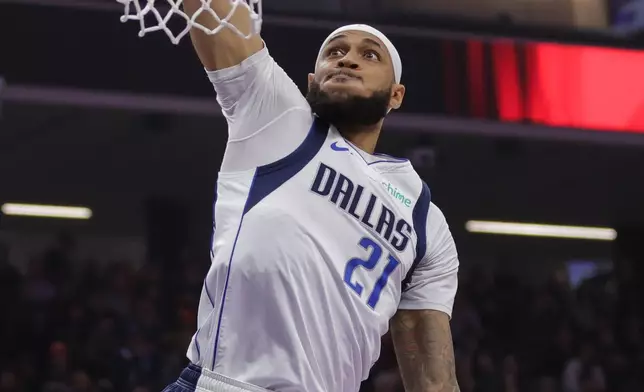 Dallas Mavericks forward Daniel Gafford dunks the ball during the first half of an NBA basketball game against the Sacramento Kings, Saturday, Dec. 27, 2025, in Sacramento, Calif. (AP Photo/Scott Marshall)