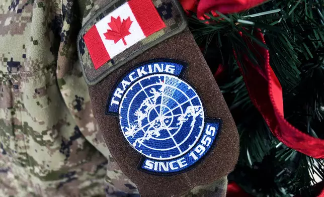 A patch representing the annual NORAD Tracks Santa Operation is seen on a military uniform sleeve at Peterson Space Force Base in Colorado Springs, Colo., on Thursday, Dec. 18, 2025. (AP Photo/Thomas Peipert)