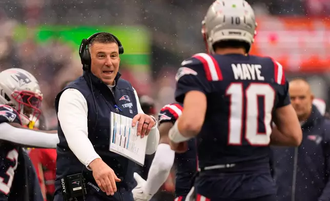 New England Patriots head coach Mike Vrabel, left, celebrates after a touchdown scored by quarterback Drake Maye (10) during the first half of an NFL football game against the Buffalo Bills in Foxborough, Mass., Sunday, Dec. 14, 2025. (AP Photo/Charles Krupa)