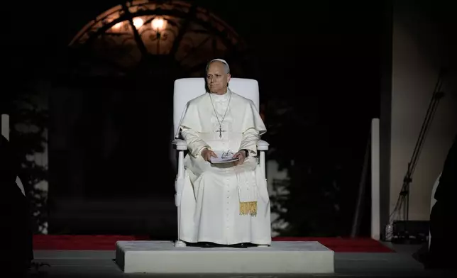 Pope Leo XIV sits onstage during a meeting with youths in Bkerki, the seat of the Maronite Church, in Lebanon, Monday, Dec. 1, 2025. (AP Photo/Bilal Hussein)