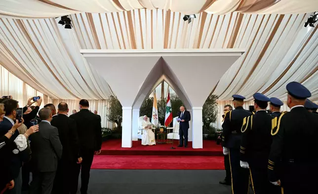 Pope Leo XIV delivers a speech next to Lebanese President Joseph Aoun during a farewell ceremony at the Beirut International Airport in Beirut, Lebanon, Tuesday, Dec. 2, 12025. (Andreas Solaro/Pool Photo via AP)