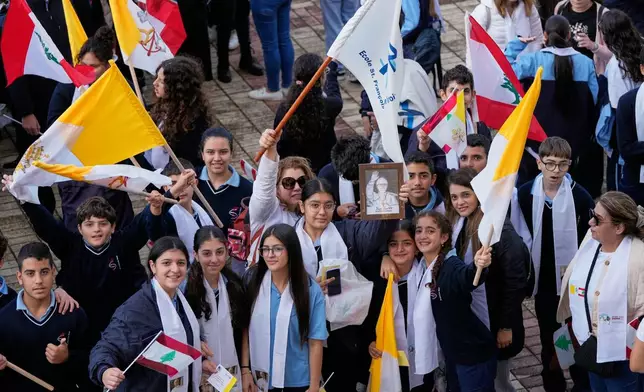 People wait for the arrival of Pope Leo XIV at the De la Croix hospital in Jal el Dib, Lebanon, Tuesday, Dec. 2, 2025. (AP Photo/Hassan Ammar)