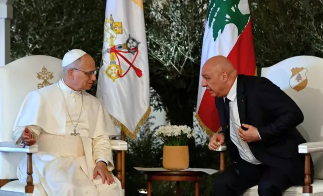 Pope Leo XIV talks with Lebanese President Joseph Aoun during a farewell ceremony at the Beirut International Airport in Beirut, Lebanon, Tuesday, Dec. 2, 12025. (Andreas Solaro/Pool Photo via AP)
