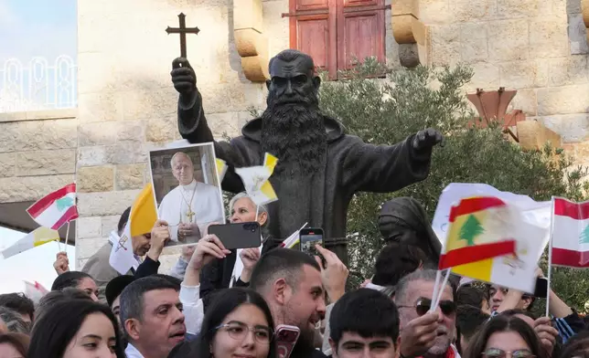 People wait for the arrival of Pope Leo XIV to visit the De la Croix hospital in Jal el Dib, Lebanon, Tuesday, Dec. 2, 2025. (AP Photo/Domenico Stinellis)