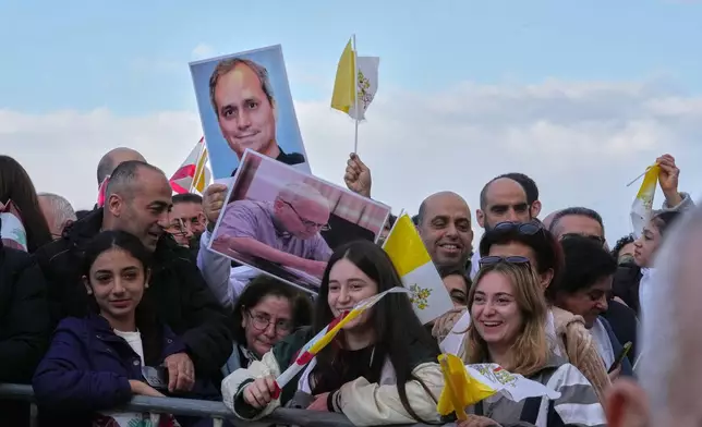 People wait for the arrival of Pope Leo XIV to visit the De la Croix hospital in Jal el Dib, Lebanon, Tuesday, Dec. 2, 2025. (AP Photo/Domenico Stinellis)