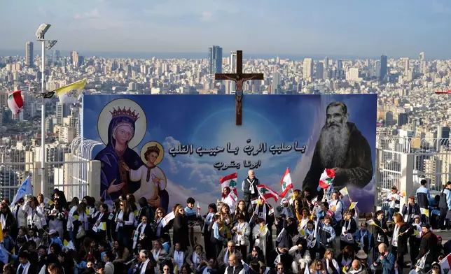 People wait for the arrival of Pope Leo XIV to visit the De la Croix hospital in Jal el Dib, Lebanon, Tuesday, Dec. 2, 2025. (AP Photo/Hassan Ammar)