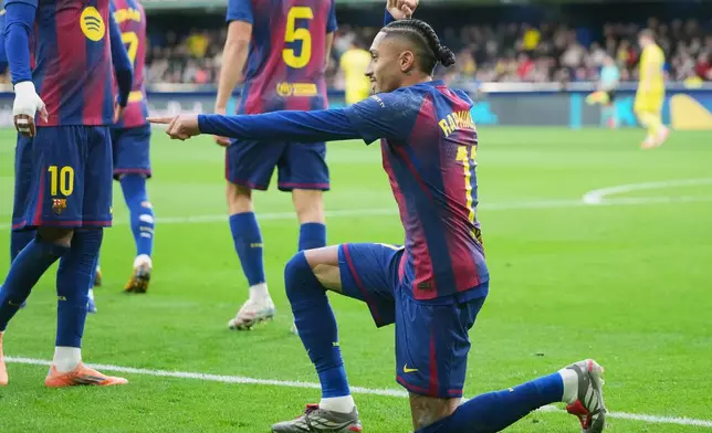 Barcelona's Raphinha celebrates after scoring the opening goal from a penalty kick during the Spanish La Liga soccer match between Villarreal and Barcelona in Villarreal, Spain, Sunday, Dec. 21, 2025. (AP Photo/Alberto Saiz)