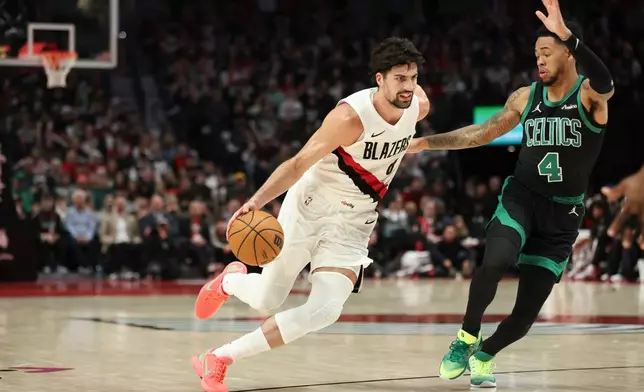 Portland Trail Blazers forward Deni Avdija drives to the ball as Boston Celtics guard Anfernee Simons (4) defends during the second half of an NBA basketball game, Sunday, Dec. 28, 2025, in Portland, Ore. (AP Photo/Amanda Loman)