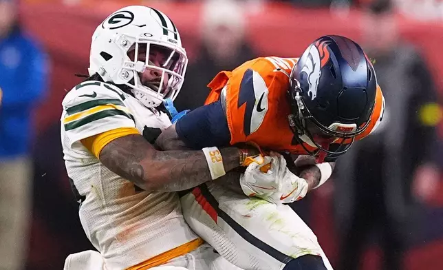 Green Bay Packers' Keisean Nixon tries to stop Denver Broncos' Troy Franklin during the second half of an NFL football game Sunday, Dec. 14, 2025, in Denver. (AP Photo/David Zalubowski)