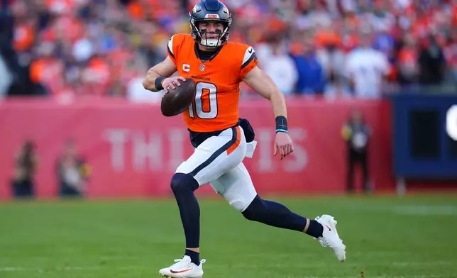 Denver Broncos' Bo Nix scrambles during the first half of an NFL football game against the Green Bay Packers Sunday, Dec. 14, 2025, in Denver. (AP Photo/Jack Dempsey)