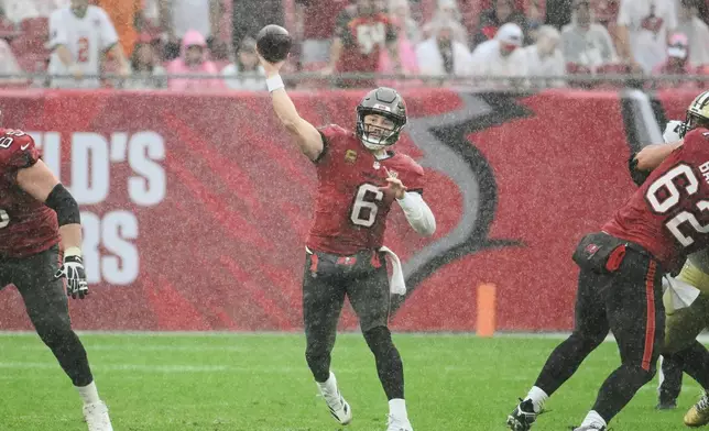 Tampa Bay Buccaneers quarterback Baker Mayfield (6) passes against the New Orleans Saints in the second half of an NFL football game, Sunday, Dec. 7, 2025, in Tampa, Fla. (AP Photo/Jason Behnken)