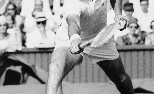 FILE - Italy's Nicola Pietrangeli returns the ball to United States' Earl Buchholz in the men's singles tennis championship at Wimbledon, London, June 22, 1959. (AP Photo/Leslie Priest, File)