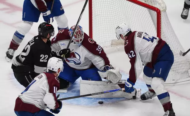 Los Angeles Kings left wing Kevin Fiala, back left, has his shot stopped by Colorado Avalanche goaltender Mackenzie Blackwood, center, as center Brock Nelson, front left, and defenseman Josh Manson cover in the first period of an NHL hockey game, Monday, Dec. 29, 2025, in Denver. (AP Photo/David Zalubowski)
