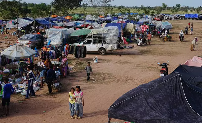 People take refuge in Wat Prasat Srahkandal, Banteay Menchey province, Cambodia Sunday, Dec. 14, 2025, after fleeing home following fighting along the Thailand-Cambodia border. (AP Photo/Heng Sinith)