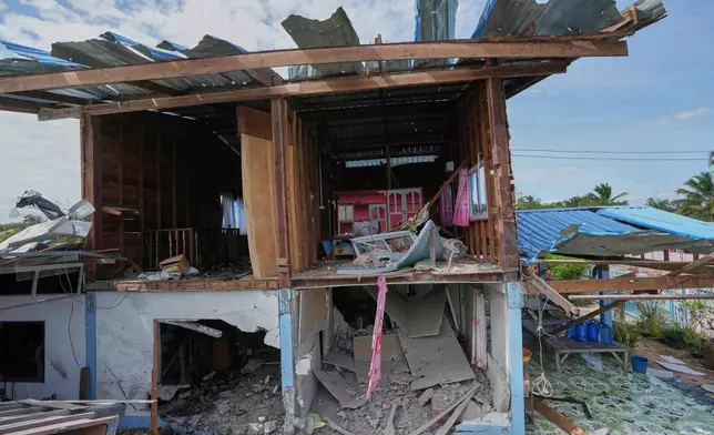A house is seen damaged following a Thai soldier said was a Cambodian artillery strike in Sisaket province, Thailand, Sunday, Dec. 14, 2025. (AP Photo/Sakchai Lalit)