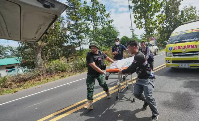 Thai rescue team members move a body into a vehicle after a Cambodian artillery strike in Sisaket province, Sunday, Dec. 14, 2025. (AP Photo/Sakchai Lalit)