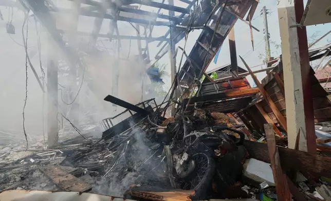 A damaged house is seen after what Thai soldiers said was a Cambodian artillery strike in the area in Sisaket province, Thailand, Sunday, Dec. 14, 2025. (AP Photo/Sakchai Lalit)